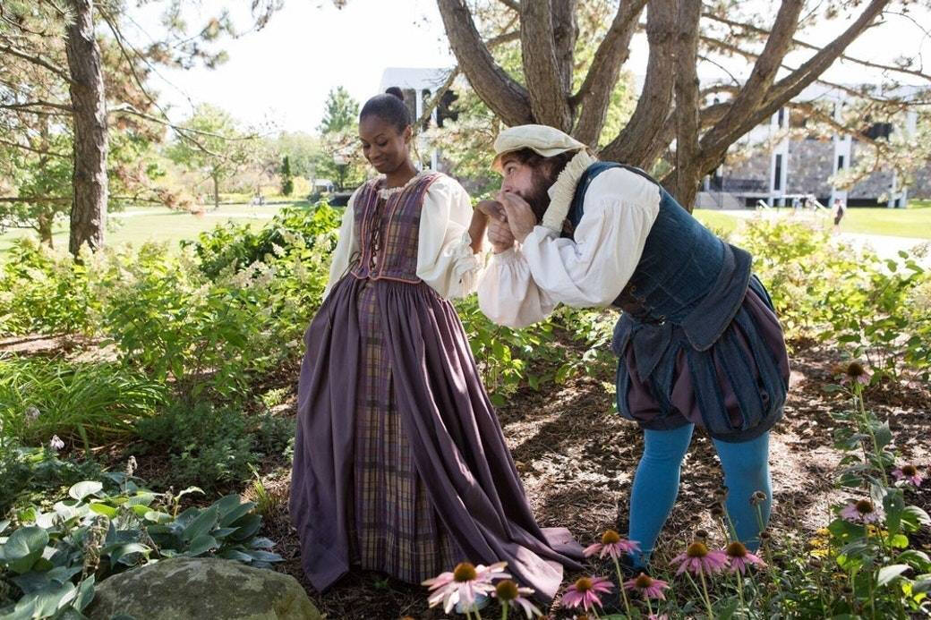 Two people outside in Shakesperean dress.